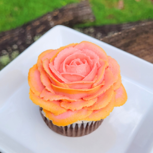 orange buttercream rose on plate